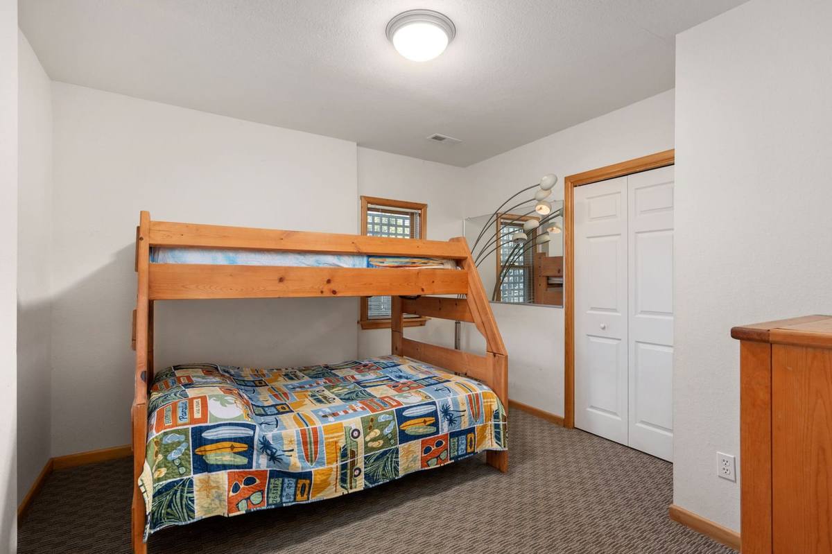Bedroom 1 on the bottom level, bright and casually furnished