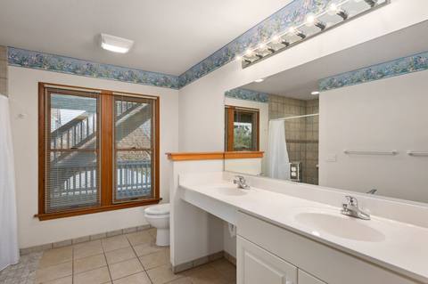 Bedroom 3's private bathroom with a double vanity and accessible shower