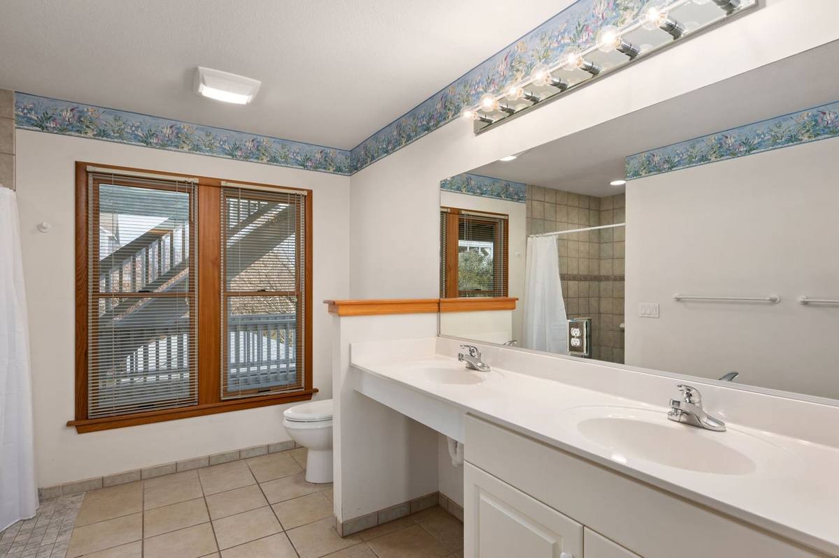Bedroom 3's private bathroom with a double vanity and accessible shower