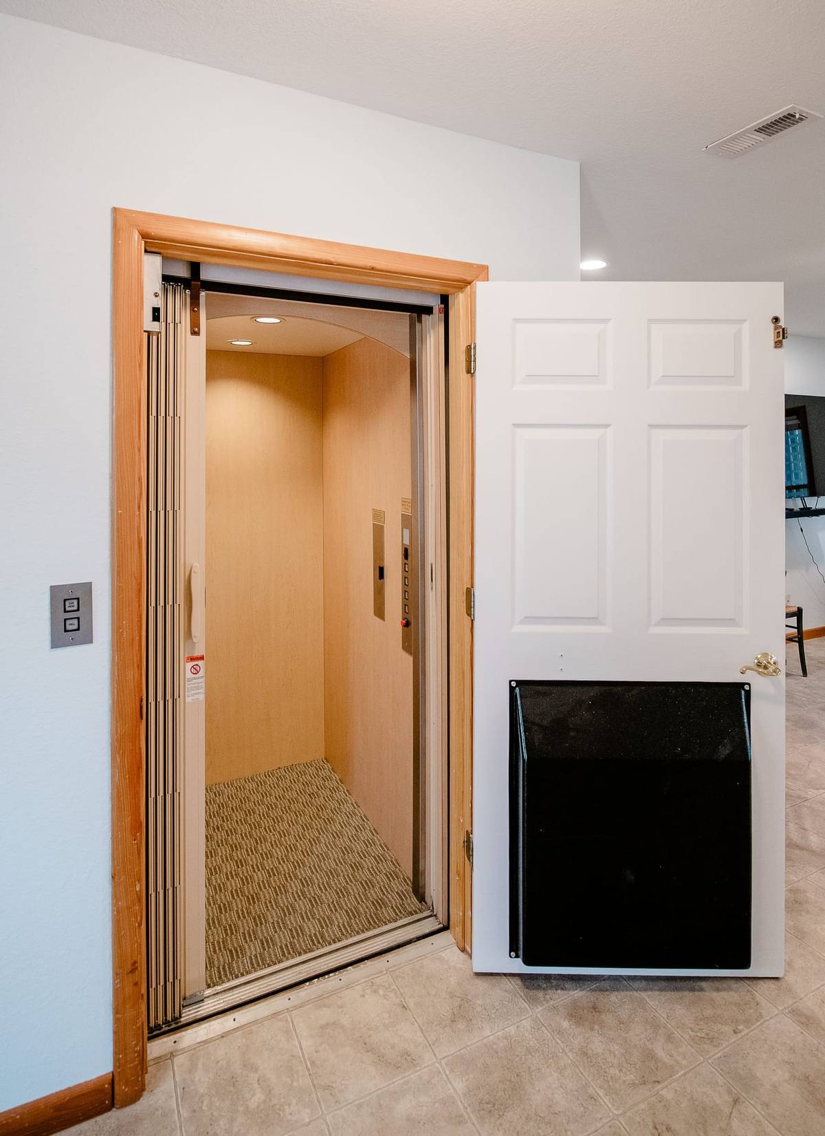 Elevator doors on the lower level beside a white door