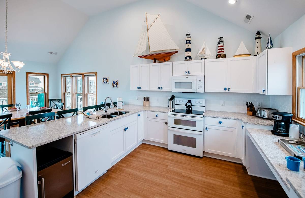 Kitchen counters, double oven, and dishwasher seen from the dining side