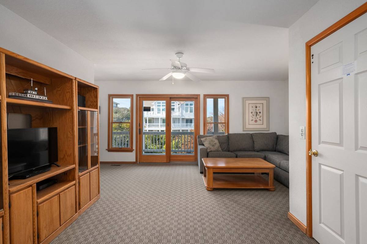 Mid-level den with a television and additional seating