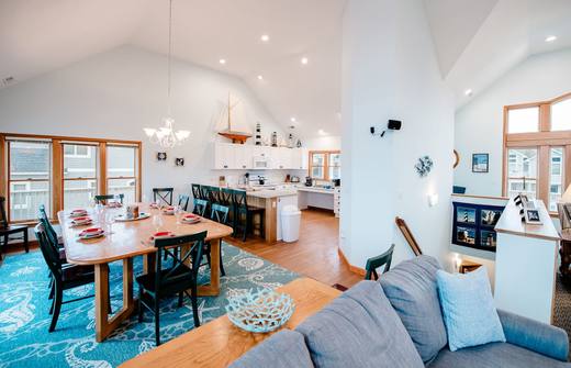 Open kitchen, dining table, and living room on the top level