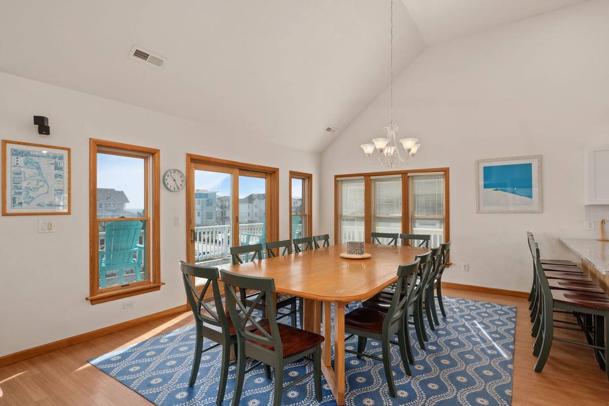Top-level dining table with seating for a large group, next to the kitchen