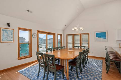 Top-level dining table with seating for a large group, next to the kitchen