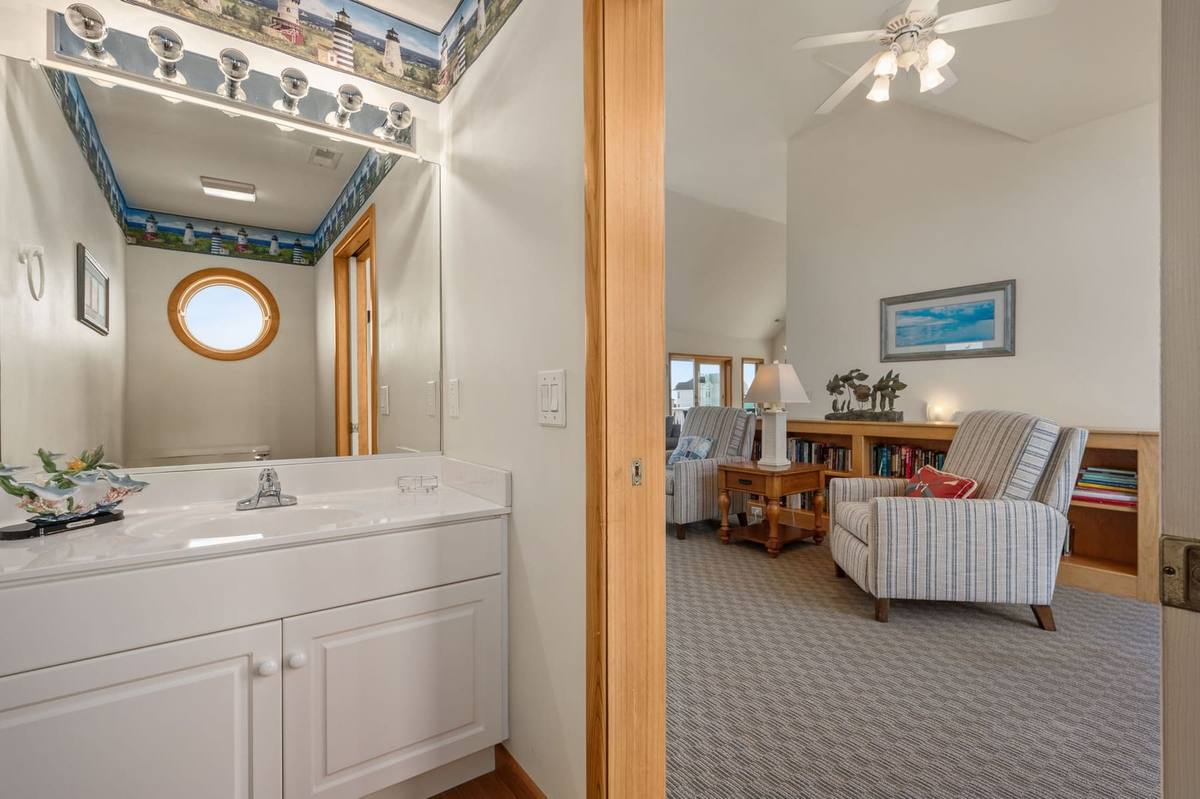 Top-level half bathroom with lighthouse-themed decor